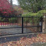 A personalised, black iron automated gate