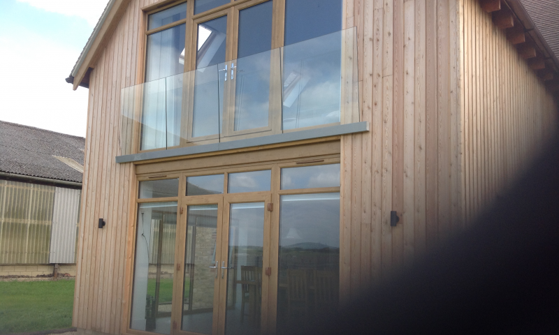 A clear, bespoke glass panel balcony