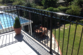 A metal railing balcony situated in the garden