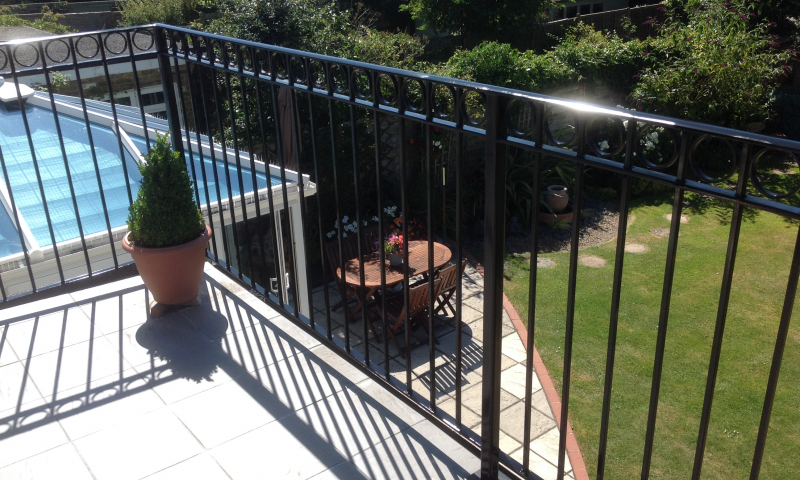 A metal railing balcony situated in the garden