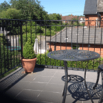 A metal railing balcony overlooking the countryside