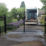A metal gate leading to a domestic house