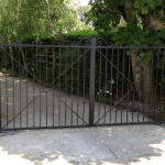 A square, black metal gate
