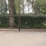 A Square, black gate with golden spikes