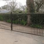 A Square, black gate with golden spikes