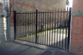 A metal gate with the sun shining in the background