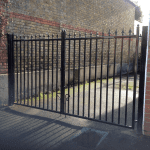 A metal gate with the sun shining in the background