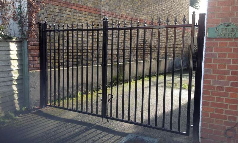 A metal gate with the sun shining in the background