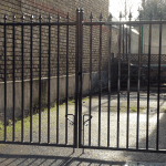 A close up of a black metal gate