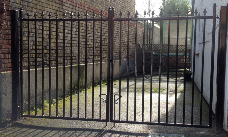 A close up of a black metal gate