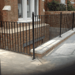 A metal railing guarding a steep drop