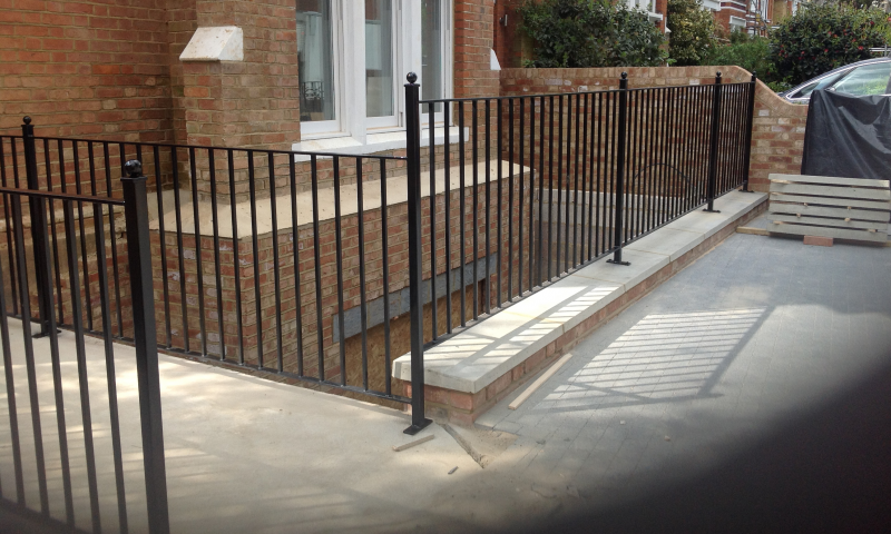 A metal railing guarding a steep drop